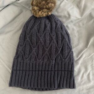 Elegant Black Knit Beanie with Brown Pom-Pom